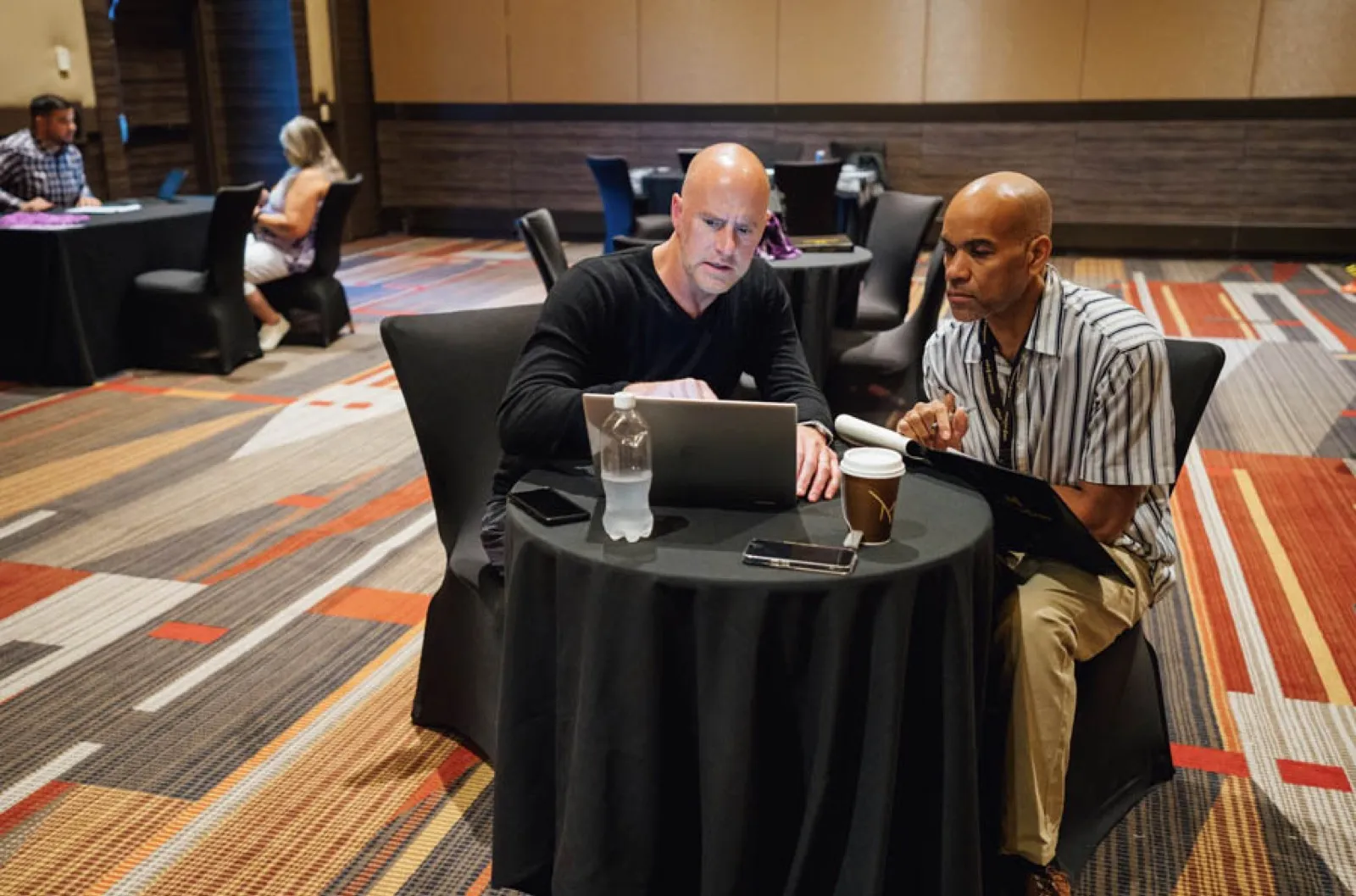Tax lien investing mentor coaching a student one-on-one at a workshop